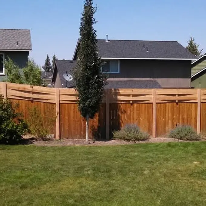 Fence bordering a green lawn